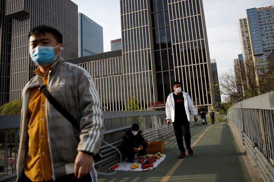 People wearing face masks walk on an overpass in Beijing's central business area, amid an outbreak of the novel coronavirus disease (COVID-19) in the country, China on April 5, 2020  — Reuters photo