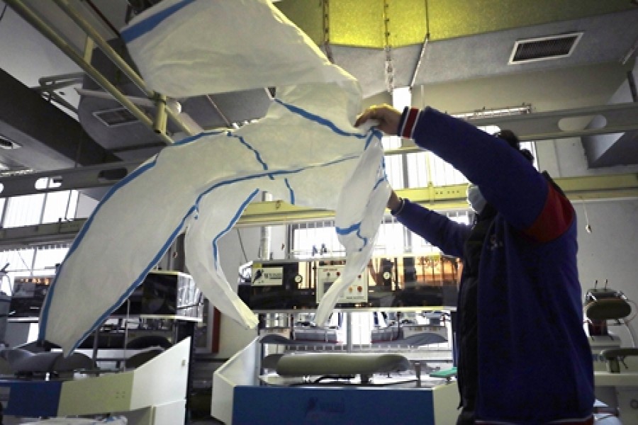 A worker at Jiangsu Casdilly Dress Co, a protective gear manufacturer, checks a protective suit at the company's factory in Nanjing, East China's Jiangsu Province, on February 4. Photo: Yang Hui/GT   