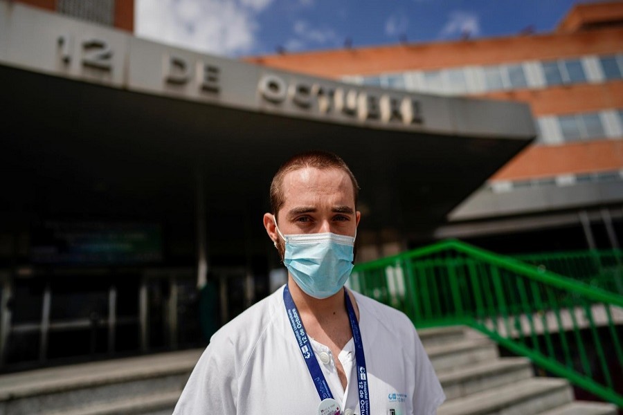 Christian Vigil, 26, an intensive care doctor, poses at the main entrance of the 12 de Octubre hospital during the coronavirus disease (COVID-19) outbreak, in Madrid, Spain, April 08, 2020. – Reuters