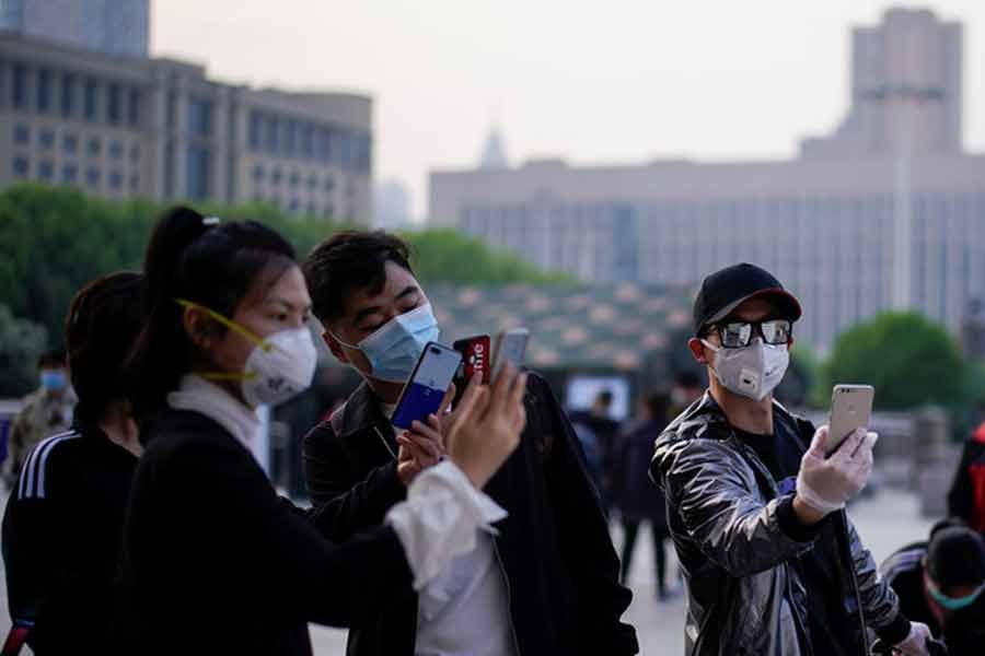 People scanning a health QR code at Wuhan's Hankou Railway Station as travel restrictions for leaving the city, the epicentre of a global coronavirus disease (COVID-19) outbreak, are lifted and people will be allowed to leave the city via road, rail and air, in Wuhan, Hubei, China on April 8. –Reuters Photo