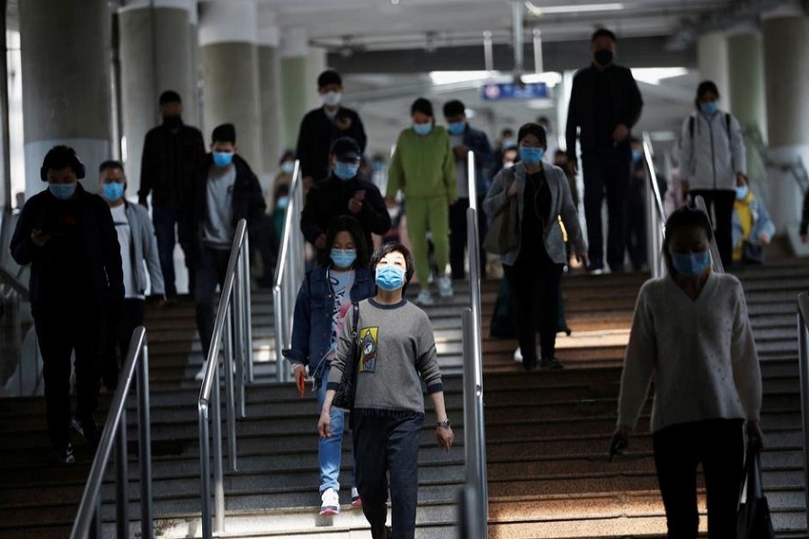 People wearing face masks walk inside a subway train during morning rush hour in Beijing, as the spread of the novel coronavirus disease (COVID-19) continues in the country, China, April 14, 2020. — Reuters