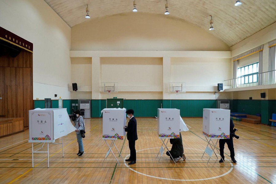 Media members cover inside a polling station for parliamentary election in Seoul, South Korea on April 14, 2020 — Reuters/Files