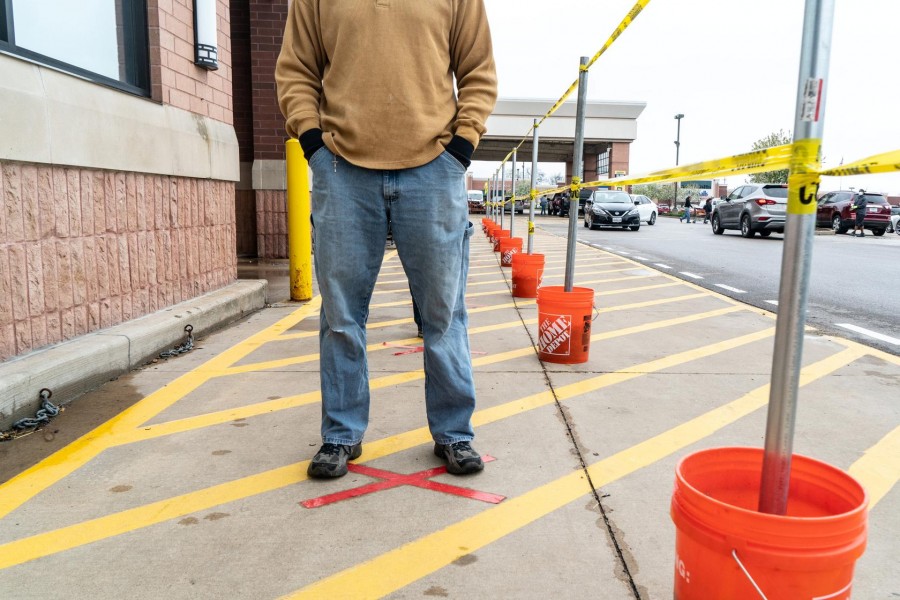 A shopper lines up to enter a Home Depot building supplies store while practicing social distancing to help slow the spread of coronavirus disease (COVID-19) in north St. Louis, Missouri, US April 4, 2020. Picture taken April 4, 2020. REUTERS/Lawrence Bryant