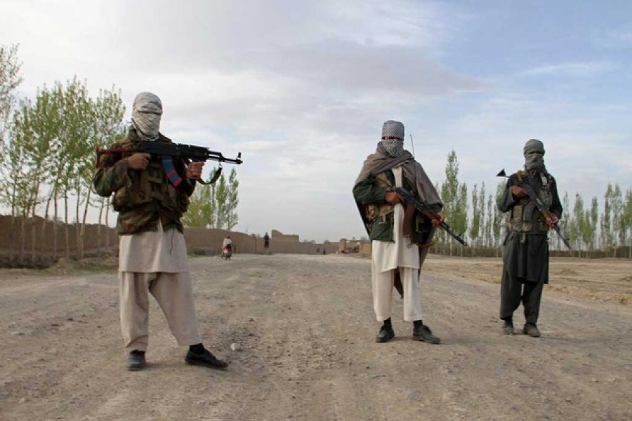 Members of the Taliban stand at the site of the execution of three men in Ghazni province, Afghanistan, April 18, 2015. — Reuters/Files