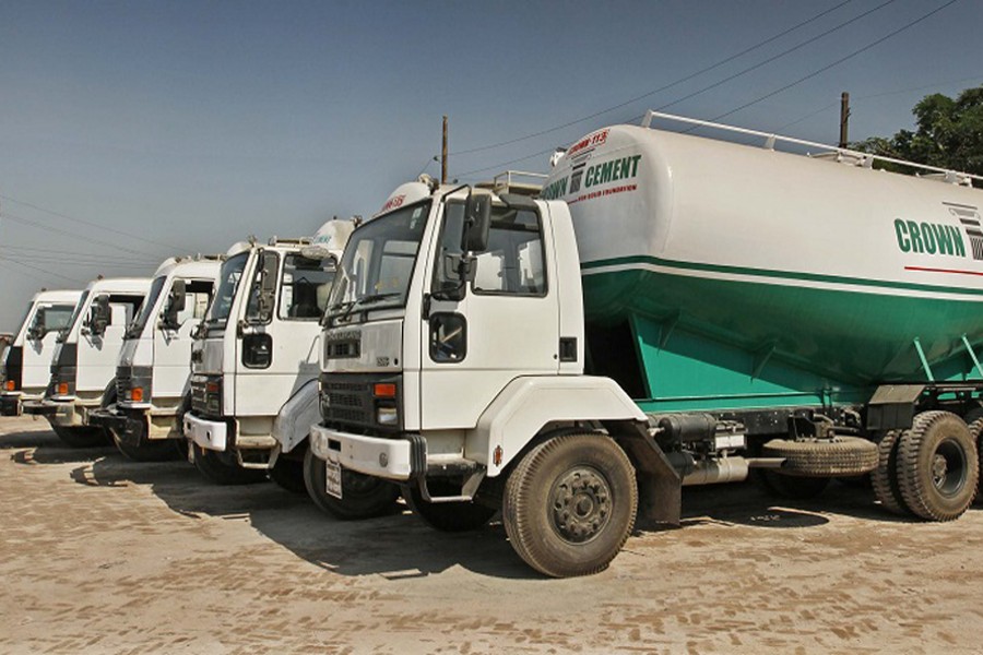 Ready mix concrete trucks are parked idle at a facility of Crown Cement Group