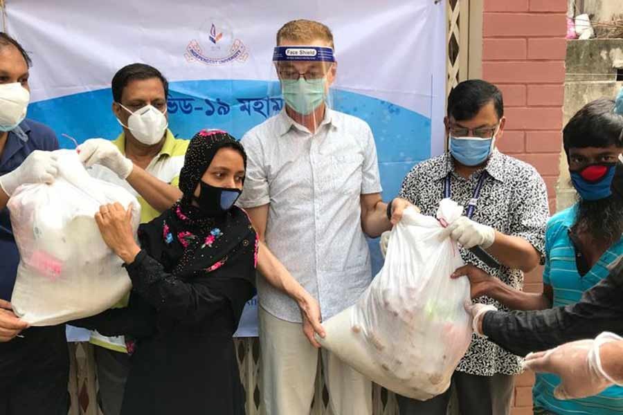 IUB distributes relief materials among disadvantaged people