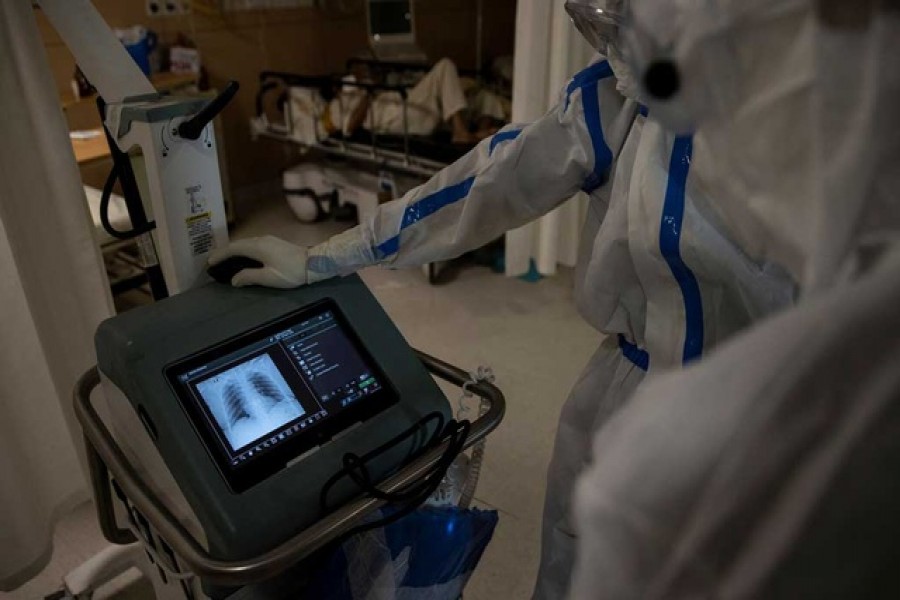 Medical workers wearing personal protective equipment (PPE) look at the reports of a patient suffering from the coronavirus disease (COVID-19) at the emergency ward of Max Smart Super Speciality Hospital in New Delhi, India, May 28, 2020. — Reuters