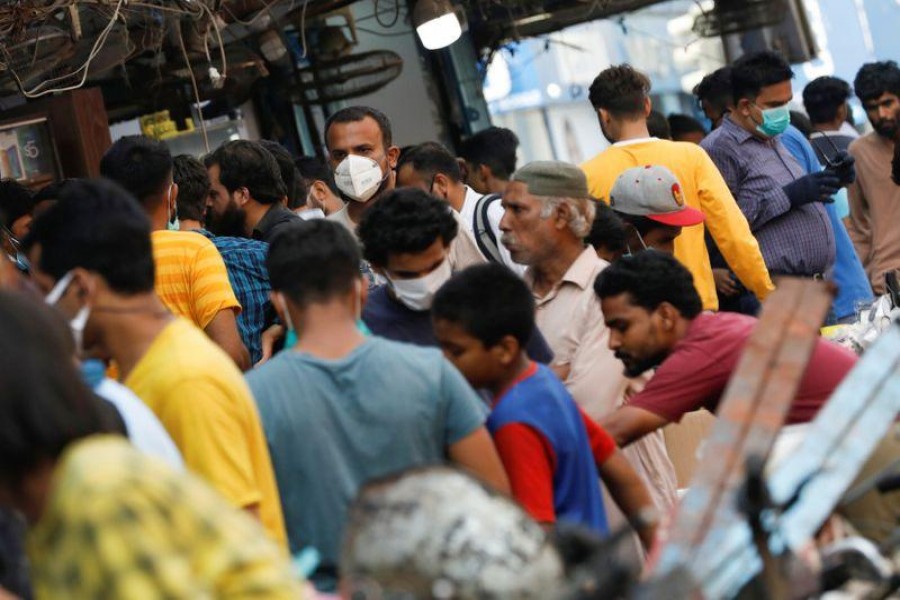 A man wearing a protective face mask walks amidst the rush of people outside an electronics market, after Pakistan started easing the lockdown restrictions, as the outbreak of the coronavirus disease (COVID-19) continues, in Karachi, Pakistan on June 4, 2020 — Reuters photo