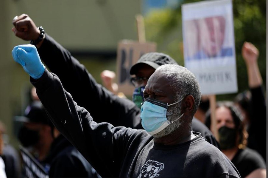 Trolice Flavors holds up a fist during a "We Want to Live" march and protest against racial inequality in the aftermath of the death in Minneapolis police custody of George Floyd, in Seattle, Washington, U.S. June 7, 2020. REUTERS/Lindsey Wasson