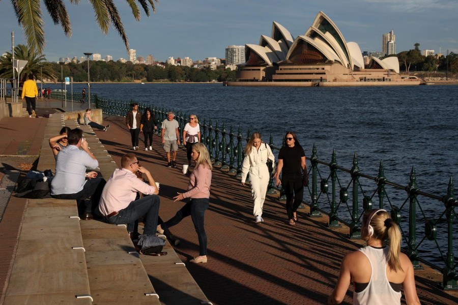 People enjoy a sunny evening by the water in front of the Sydney Opera House amidst the easing of the coronavirus disease (COVID-19) restrictions in Sydney, Australia on May 20, 2020 — Reuters/Files