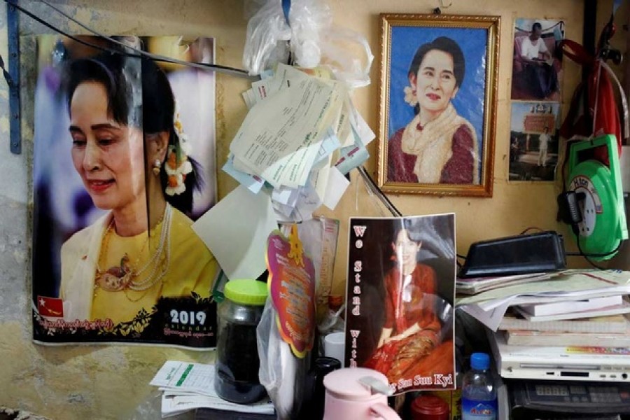 Photographs of Myanmar State Counsellor Aung San Suu Kyi hung in a shop in Yangon, Myanmar, January 23, 2020. REUTERS