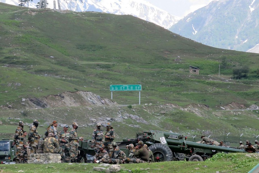 Indian army soldiers rest next to artillery guns at a makeshift transit camp before heading to Ladakh, near Baltal, southeast of Srinagar on June 16, 2020 — Reuters/Stringer