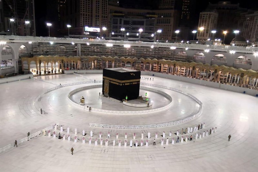 A small group of worshippers pray at Kaaba in the Grand Mosque while practicing social distancing, following the outbreak of the coronavirus disease (Covid-19), during the holy month of Ramadan, in the holy city of Mecca, Saudi Arabia on May 4, 2020 — Saudi Press Agency/Handout via REUTERS