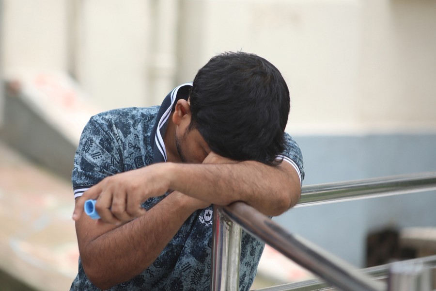 A man with Covid-19 symptoms cuts a dejected figure outside Mitford Hospital in Dhaka after getting tired of waiting for coronavirus test — File photo