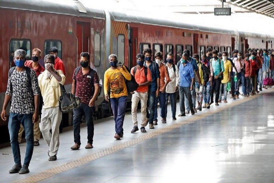 Migrant workers and their families, who had left during a lockdown, walk at a platform after they returned from their home state of Uttar Pradesh, after authorities eased lockdown restrictions that were imposed to slow the spread of the coronavirus disease (Covid-19), in Ahmedabad, July 01, 2020 — Reuters/Files