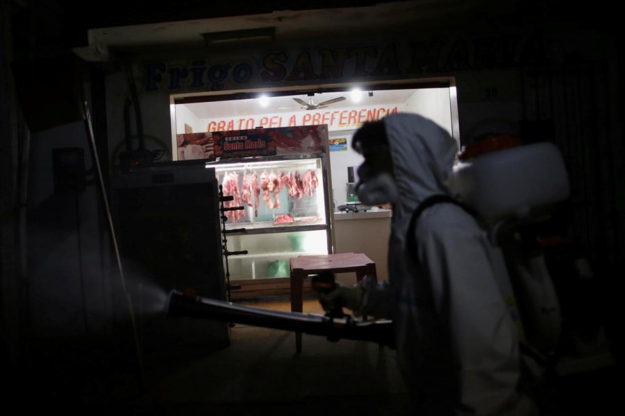 A street cleaner disinfects a street wearing protective clothing (PPE), during the coronavirus disease (Covid-19) outbreak, in the municipality of Breves, on Marajo island, Para state, Brazil on June 3, 2020 — Reuters/Files