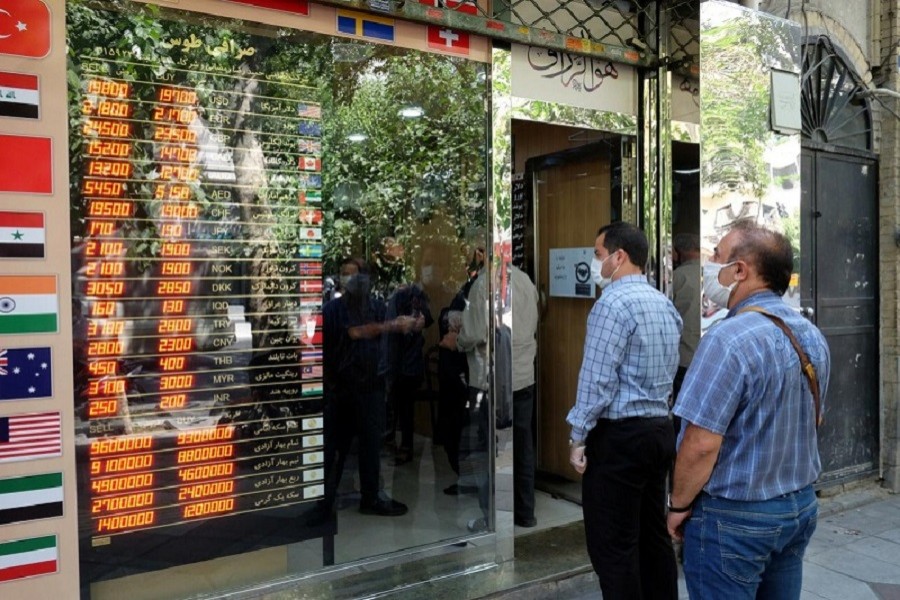 People wear protective face masks as they look at the electronic currency board at Ferdowsi square in Tehran, Iran. July 02, 2020. Picture taken July 2, 2020 — Mohamadreza Nadimi/WANA (West Asia News Agency) via Reuters attention editors - this picture was provided by a third party