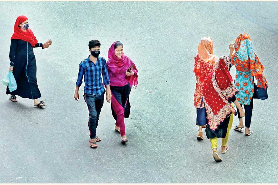 Garment workers on the way to work on Tuesday morning in the city’s Khilgaon area as life is going on amid the Covid-19 pandemic — FE Photo by Shafiqul Alam