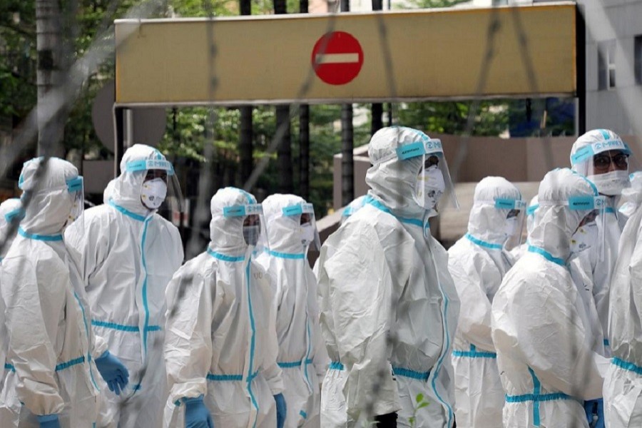 Police officers wearing protective suits gather outside an apartment under enhanced lockdown to pick up illegal immigrants, during the movement control order due to the outbreak of the coronavirus disease (Covid-19), in Kuala Lumpur, Malaysia, May 01, 2020 — Reuters/Files