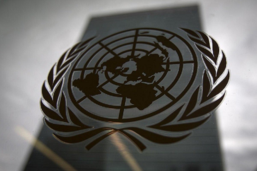 The United Nations headquarters building is pictured though a window with the UN logo in the foreground in the Manhattan borough of New York August 15, 2014 — Reuters/Files