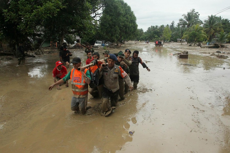 Officers evacuate victims in Radda Village, following flash floods that left several dead and dozens remain missing, in North Luwu in Sulawesi, Indonesia July 14, 2020. Antara Foto/Indra/ via REUTERS