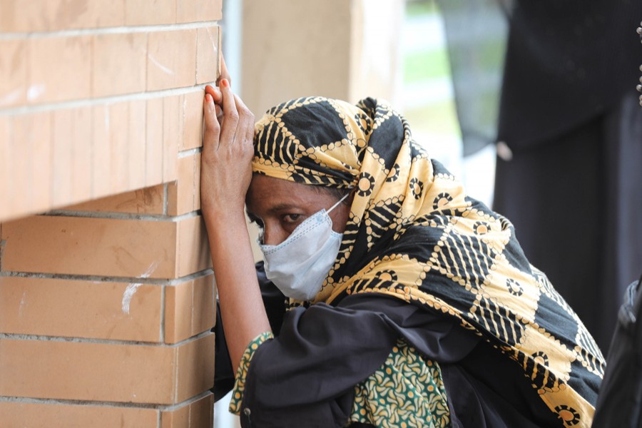 A woman with Covid-19 symptoms cuts a dejected figure outside Mugda General Hospital as she gets tired of waiting for coronavirus test  — File photo