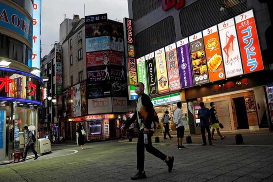 A man wearing a face mask makes his way at the Kabukicho district, amid the coronavirus disease (COVID-19) outbreak in Tokyo, Japan, July 14, 2020. REUTERS/Kim Kyung-Hoon