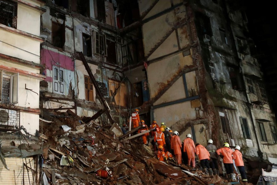 National Disaster Response Force (NDRF) and fire brigade personnel look for survivors trapped in the debris after part of a residential building collapsed following heavy rains in Mumbai, India on July 16, 2020 — Reuters photo