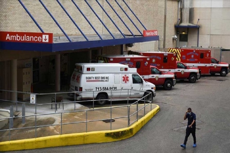 A medical worker walks past a row of ambulances parked outside of Houston Methodist Hospital as storm clouds gather over the Texas Medical Center, amid the global outbreak of the coronavirus disease (Covid-19), in Houston, Texas, US, June 22, 2020 — Reuters/Files