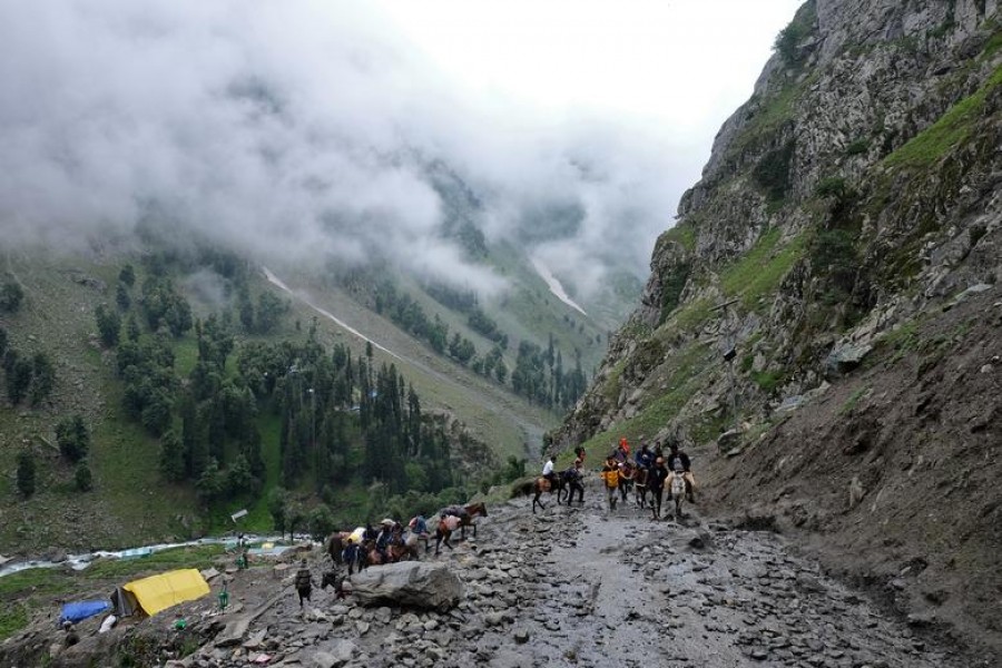 Hindu pilgrims trek through mountains to reach the holy Amarnath cave shrine, where they worship an ice stalagmite that Hindus believe to be the symbol of Lord Shiva, near Pahalgam in the Kashmir region, July 27, 2019. REUTERS/Alasdair Pal