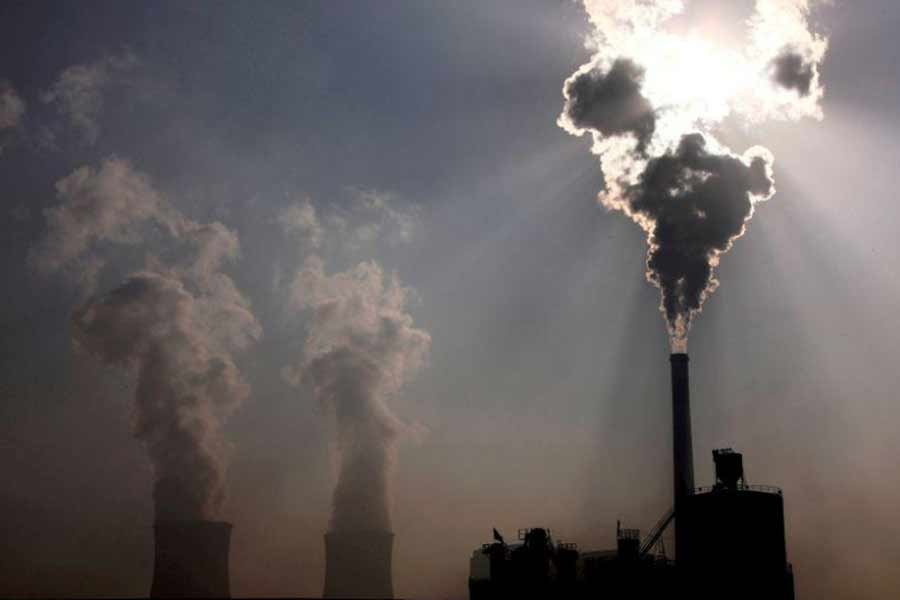 A coal-burning power plant can be seen behind a factory in the city of Baotou, in China's Inner Mongolia Autonomous Region –Reuters file photo