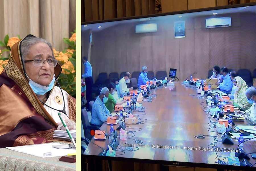 Prime Minister Sheikh Hasina presiding over the cabinet meeting through a videoconference from her official residence Ganabhaban, while other cabinet members were connected from the secretariat –PID Photo