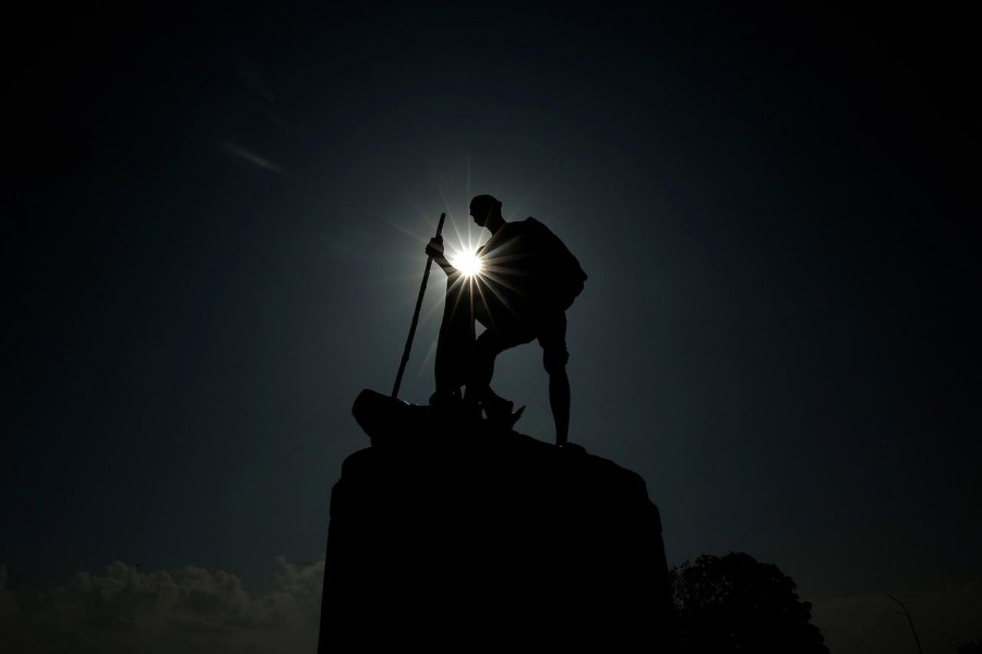 A statue of Mahatma Gandhi is silhouetted during partial solar eclipse in Chennai, India on December 26, 2019 — Reuters/Files