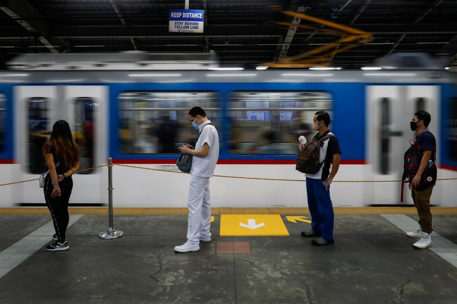 Passengers wearing face masks for protection against the coronavirus disease (Covid-19) maintain social distancing while queueing to ride a train in Quezon City, Metro Manila, Philippines on July 21, 2020 — Reuters/Files