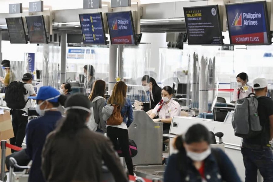 People wait before check-in counters at Chubu Centrair International Airport in Tokoname, Aichi Prefecture, on June 17 as the airport resumed some international flights - KYODO