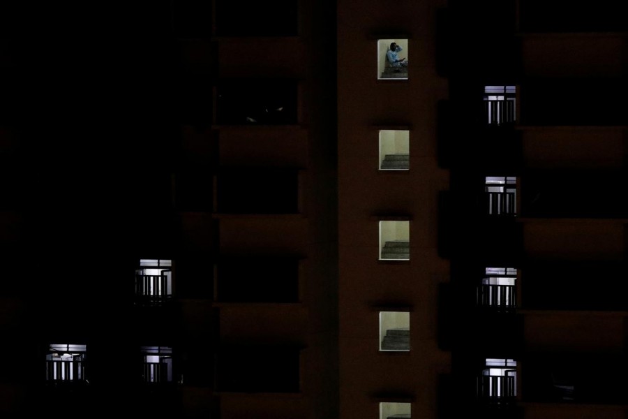 A migrant worker sits outside his room in a dormitory amid the coronavirus disease (Covid-19) outbreak in Singapore on April 30, 2020 — Reuters/Files