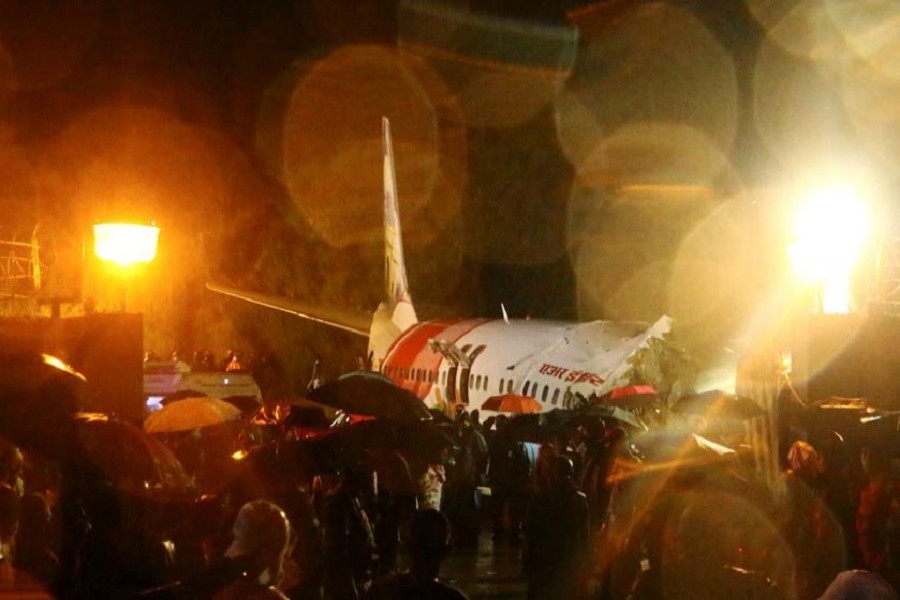 Rescue workers look for survivors after a passenger plane crashed when it overshot the runway at the Calicut International Airport in Karipur, in the southern state of Kerala, India, August 07, 2020 — Reuters