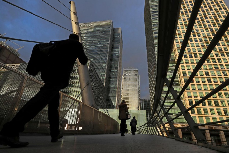 People walk through the Canary Wharf financial district of London, Britain, December 7, 2018. REUTERS/Simon Dawson/File Photo