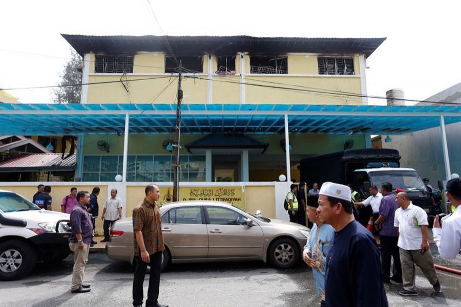 FILE PHOTO: Authorities work at religious school Darul Quran Ittifaqiyah after a fire broke out in Kuala Lumpur, Malaysia September 14, 2017. REUTERS/Lai Seng Sin/File Photo