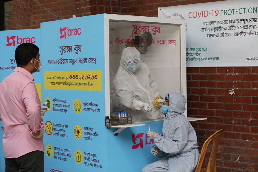  A medical worker collects a sample for Covid-19 testing at a hospital in Dhaka   — Xinhua Photo