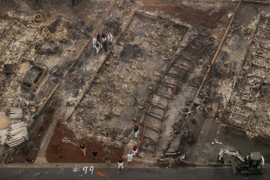 Personnel encircle remains of a fire victim in the Bear Lakes Estates neighbourhood which was left devastated by the Almeda fire in Phoenix, Oregon, US, September 12, US — Reuters