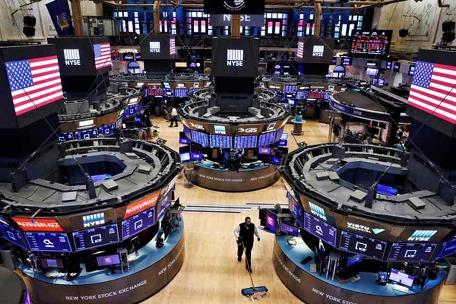 A worker cleaning the floor of the New York Stock Exchange (NYSE), March 20, 2020. –Reuters file photo