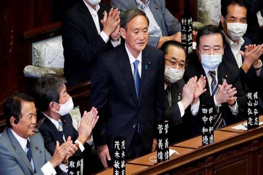 Japan's newly-elected Prime Minister Yoshihide Suga stands as he was chosen as new prime minister at the Lower House of Parliament in Tokyo, Japan September 16, 2020. REUTERS/Kim Kyung-Hoon