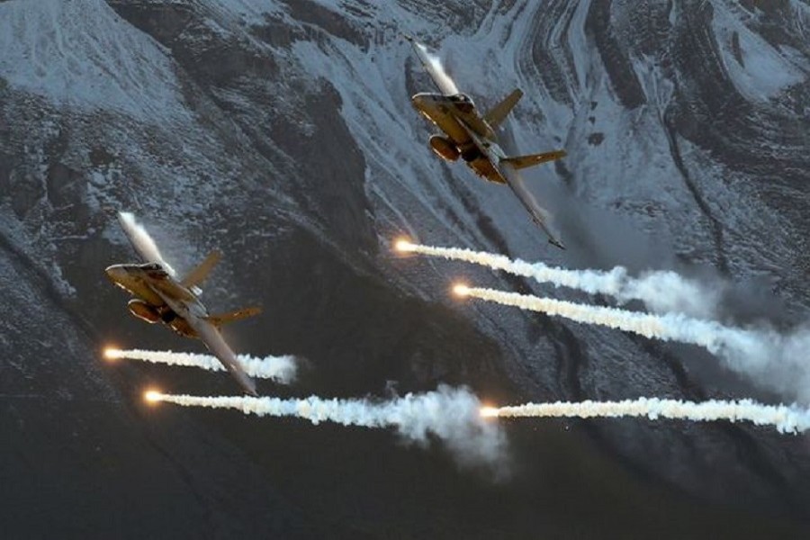 Swiss Air Force F/A18 Hornet fighter jets release flares during a flight demonstration of the Swiss Air Force over the Axalp in the Bernese Oberland, Switzerland, October 12, 2017 — Reuters/Files