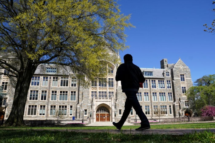 A man walks at an empty campus green at Georgetown University, closed weeks ago due to coronavirus, in Washington, US on April 3, 2020