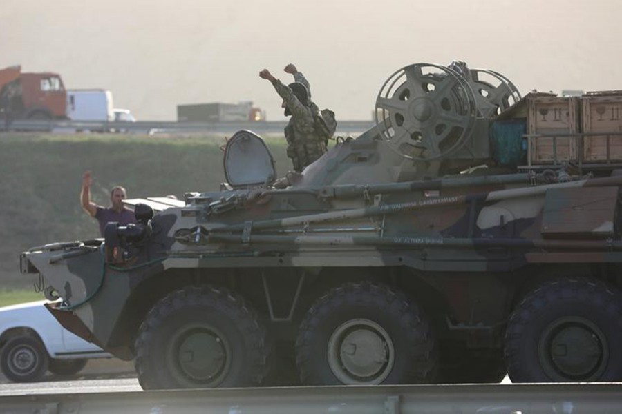 An Azerbaijani service member drives an armoured carrier and greets people, who gather on the roadside in Baku, Azerbaijan on September 27, 2020 — Reuters photo