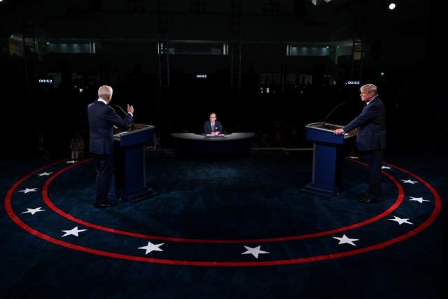 US President Donald Trump listens to Democratic presidential nominee Joe Biden during the first presidential debate at Case Western Reserve University and Cleveland Clinic in Cleveland, Ohio, US, September 29, 2020 — Reuters