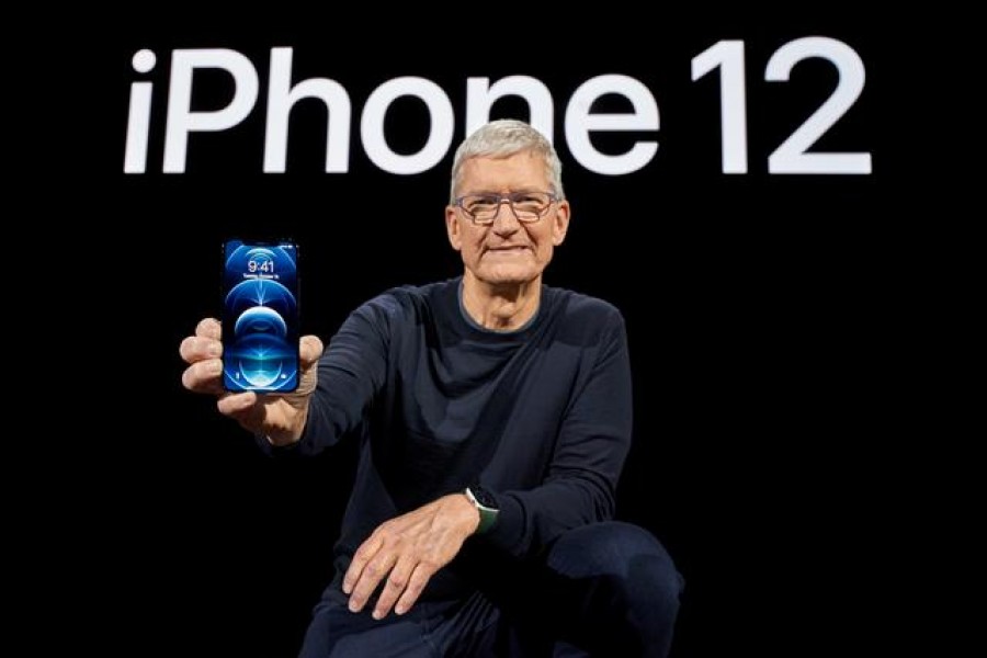 Apple CEO Tim Cook poses with the all-new iPhone 12 Pro at Apple Park in Cupertino, California, U.S. in a photo released October 13, 2020. Brooks Kraft/Apple Inc./Handout via REUTERS