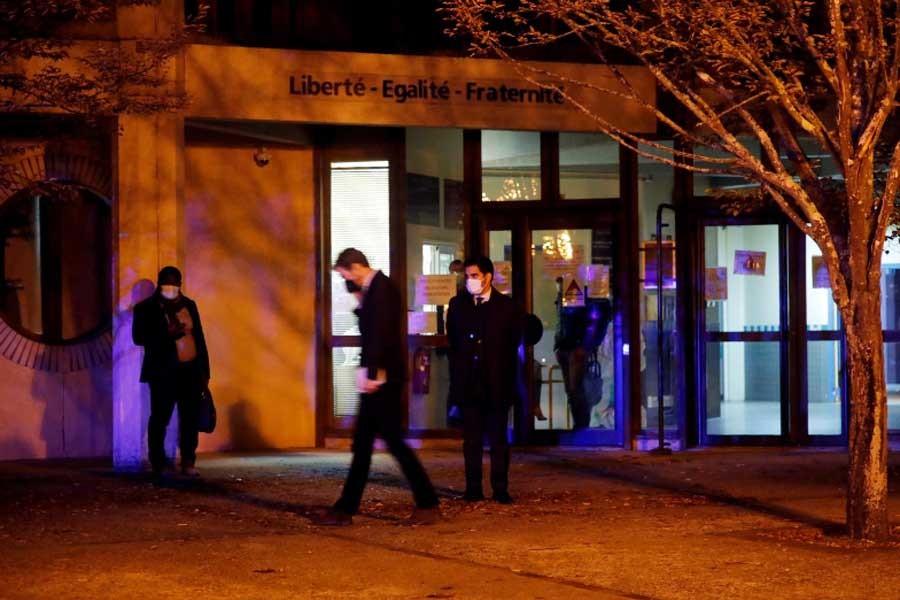 People are seen outside an entrance area near the scene of a stabbing attack in the Paris suburb of Conflans St Honorine, France, on Friday –Reuters Photo