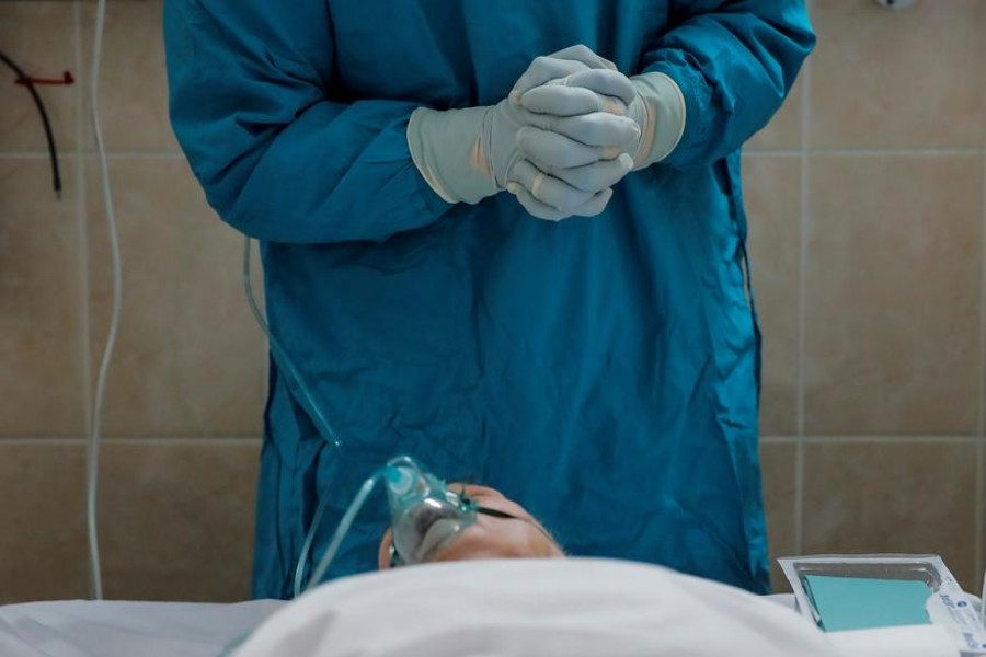 A medical worker prepares for a procedure with a patient in the intensive care unit of the City Clinical Hospital Number 52, where patients suffering from the coronavirus disease (Covid-19) are treated, in Moscow, Russia on October 8, 2020 — Reuters/Files